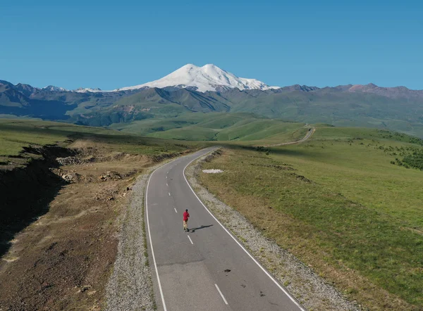 Man Riding Skateboard Road Elbrus Υψηλότερο Όρος Στην Ευρώπη Αεροπλάνο — Φωτογραφία Αρχείου