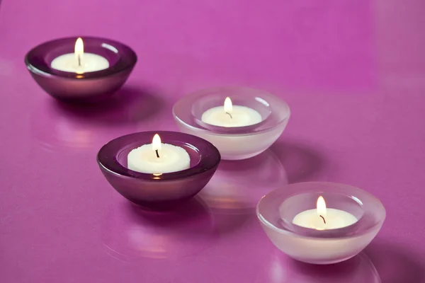 Burning candles on purple background — Stock Photo, Image