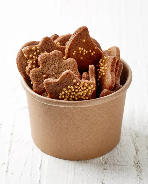 Gingerbread cookies in brown paper cup — Stock Photo, Image