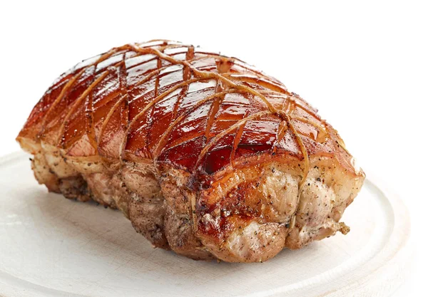 Roasted pork on wooden cutting board — Stock Photo, Image