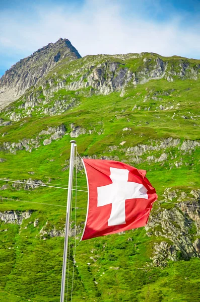 The Swiss flag is blowing in the wind