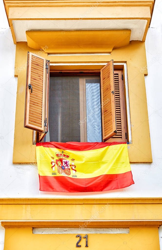 The national flag of Spain hang on the balcony