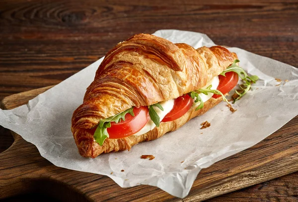 Croissant sandwich with mozzarella and tomato — Stock Photo, Image