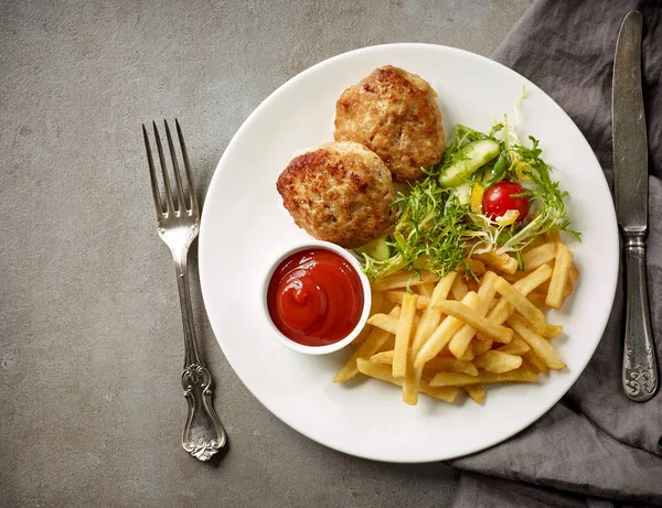 Plate of fried potatoes and cutlets — Stock Photo, Image