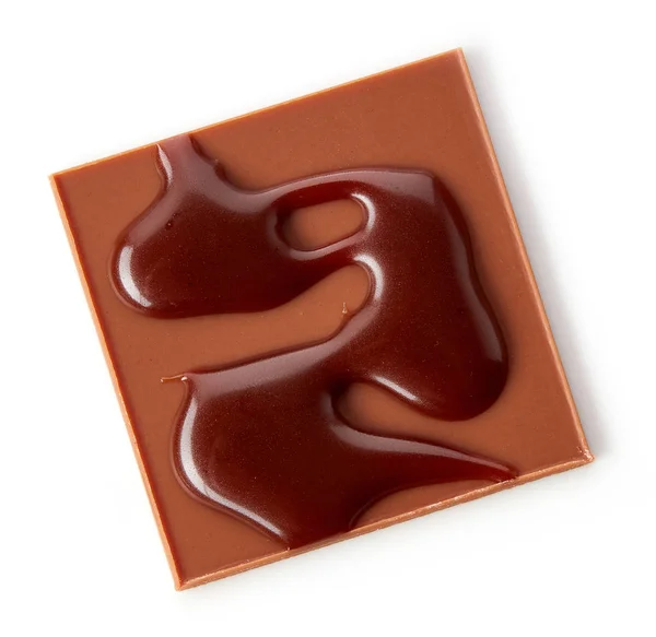 Čokoládový čtverec zdobený roztavenou čokoládou — Stock fotografie