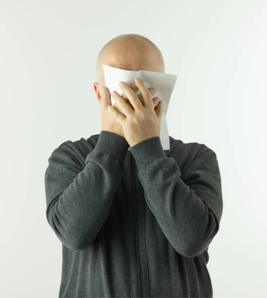 senior man with paper napkin on white background