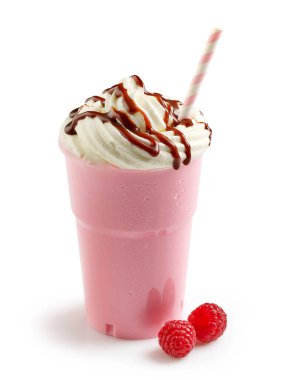 Pembe ahududulu milkshake, beyaz arka planda izole edilmiş plastik bardakta krem şantili.