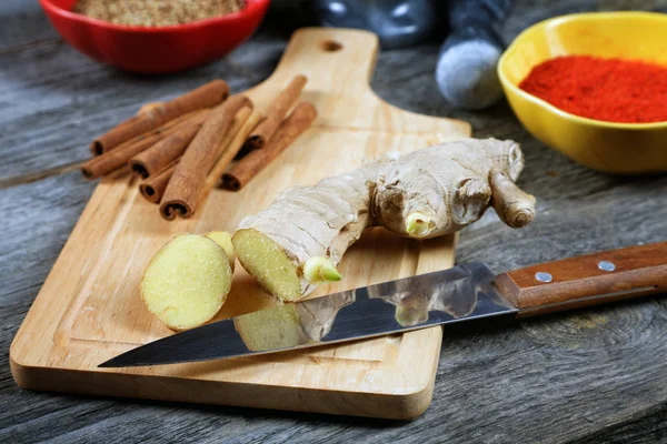 Kitchen knife ginger cinnamon on a chopping board — Stock Photo, Image