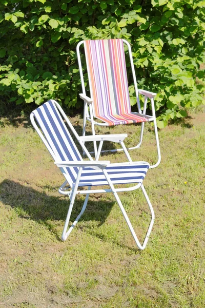 folding chairs on the lawn in the spring afternoon