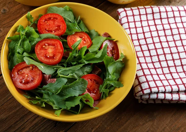 Овощной салат с помидорами и рукколой на столе — стоковое фото