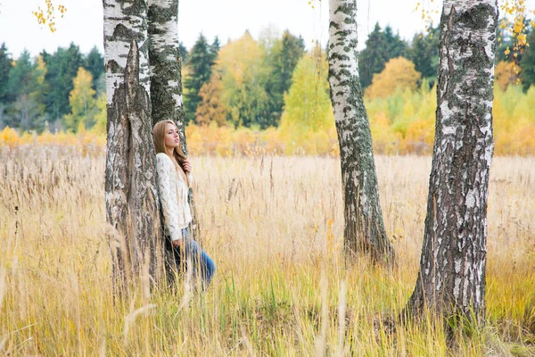 Woman among birches in the autumn field — Stock Photo, Image
