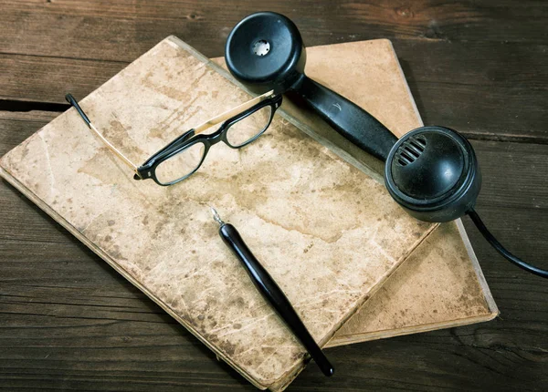 Still-life with old writing-books a nib and telephone — Stock Photo, Image