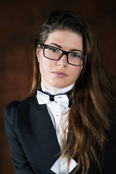 The girl with a tie-butterfly  and glasses close up — Stock Photo, Image