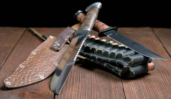 Still life with a knife and bandolier on a close-up table — Stock Photo, Image