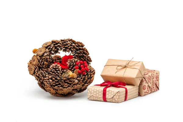 A basket of pine cones and Christmas gifts — Stock Photo, Image