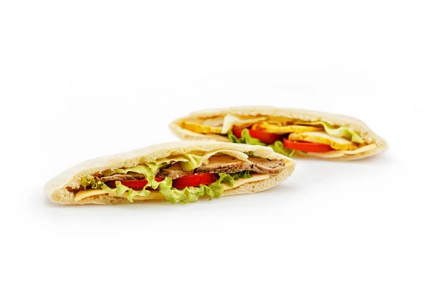 Stock image Bread pita with a filling of meat, tomatos and salad isolated on white