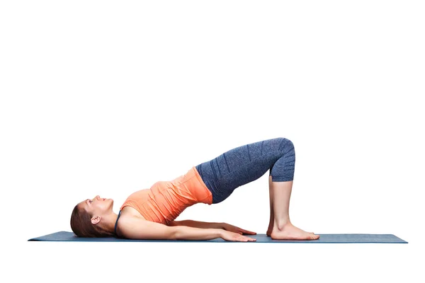 Beautiful sporty fit yogi girl practices yoga asana setu bandhasana — Stock Photo, Image