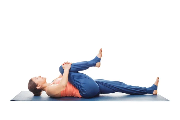 Woman doing Yoga asana Ardha pawanmuktasana isolated — Stock Photo, Image