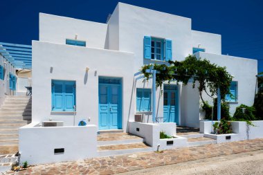 Traditional greek architecture houses painted white with blue doors and window shutters