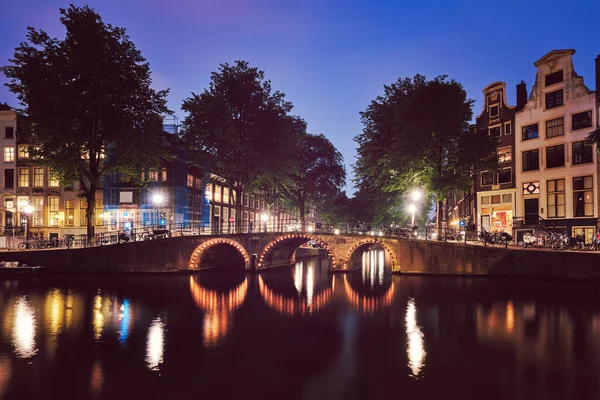 Amterdam gracht, brug en middeleeuwse huizen in de avond — Stockfoto