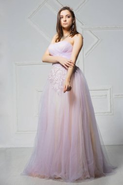 Stüdyoda poz veren zarif genç bir kadın.