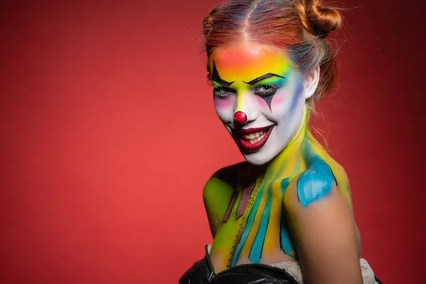 Smile young lady with a face painting clown — Stock Photo, Image