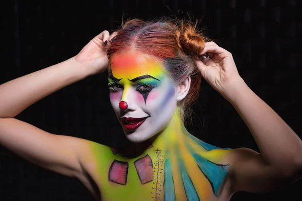 Alluring lady with a face painting clown — Stock Photo, Image
