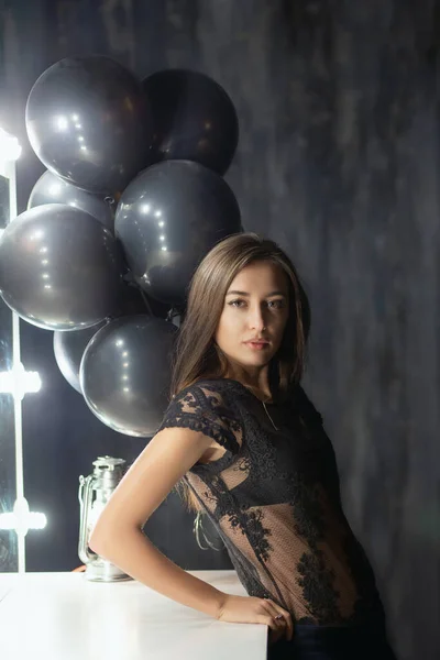 Alluring young brunette posing near a table — Stock Photo, Image