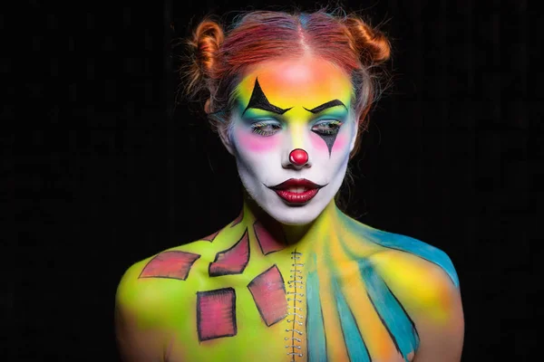 Beautiful lady with a face painting clown posing in the studio — Stock Photo, Image