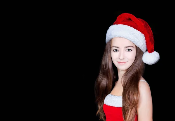 圣诞节。年轻女子在一顶帽子和打扮成圣诞老人 — 图库照片