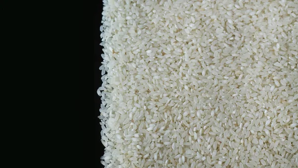 Rýže, vpravo černé pozadí — Stock fotografie