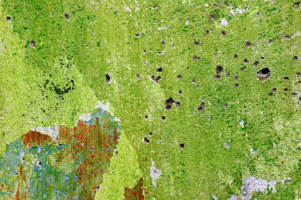 Mur vert avec des trous de balles — Photo