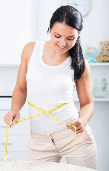 Young  woman measures waist — Stock Photo, Image