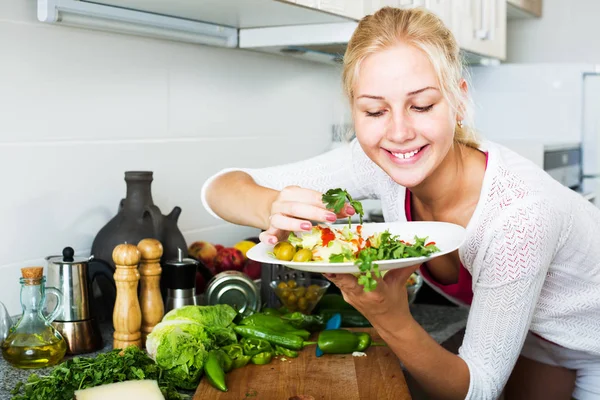 Woman serving salad on kitchen — Stock Photo, Image
