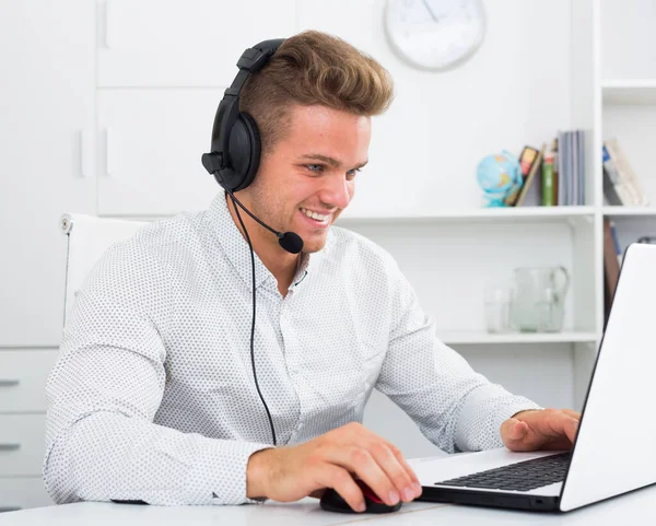 Young man working in call centre