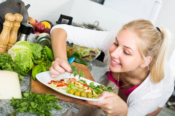 Flicka förbereda sallad på kök — Stockfoto