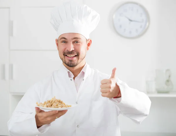 Positive cook with porridge — Stock Photo, Image