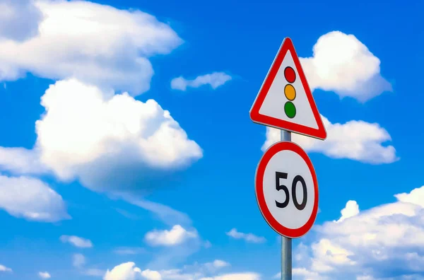 two road signs speed limit on a background of blue sky and clouds