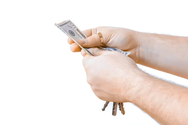 Isolated hand with cash money dollars and car key. White background. Human hands holding   keys on a — Stock Photo, Image