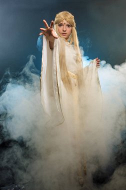 The blonde in a smoke pulls a hand