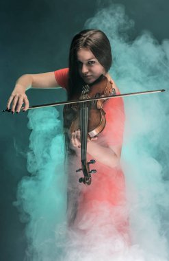The girl plays on a violin