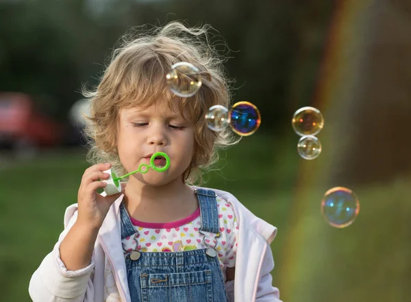 Little Girl Inflates Soap Bubbles — Stock Photo, Image