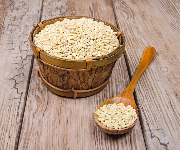 Pearl barley in wooden bowl — Stock Photo, Image