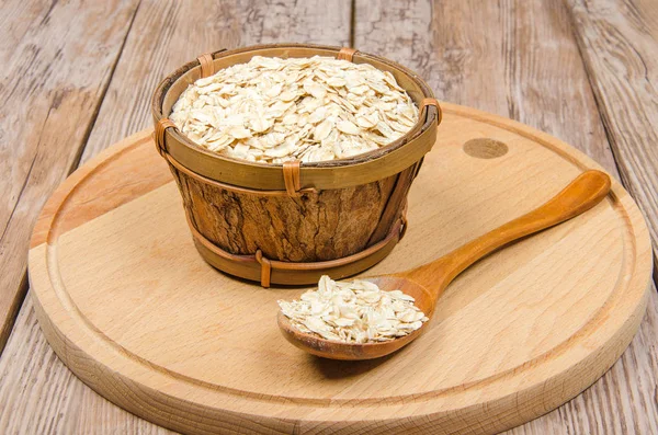 Rolled oats in wooden bowl — Stock Photo, Image