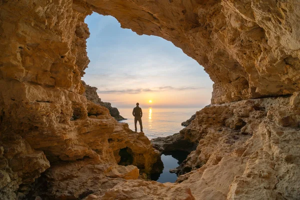 Man in sea grotto. — Stock Photo, Image