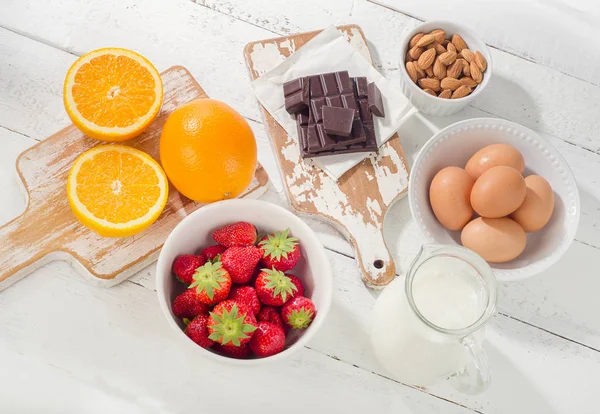 Alimentos alérgicos en una mesa de madera blanca . — Foto de Stock