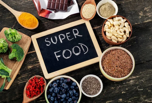 Super foods on a rustic wooden background. — Stock Photo, Image