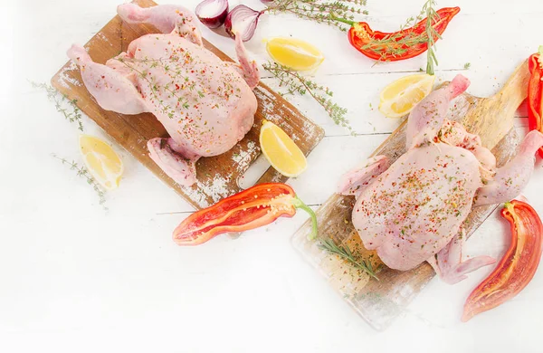 Rå kyckling med kryddor och örter på en träskiva. — Stockfoto