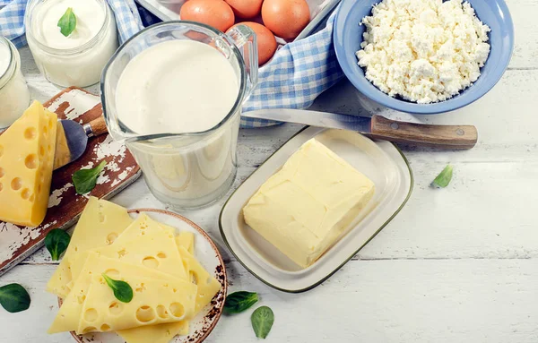 Set of fresh dairy products on white wooden table. — Stock Photo, Image