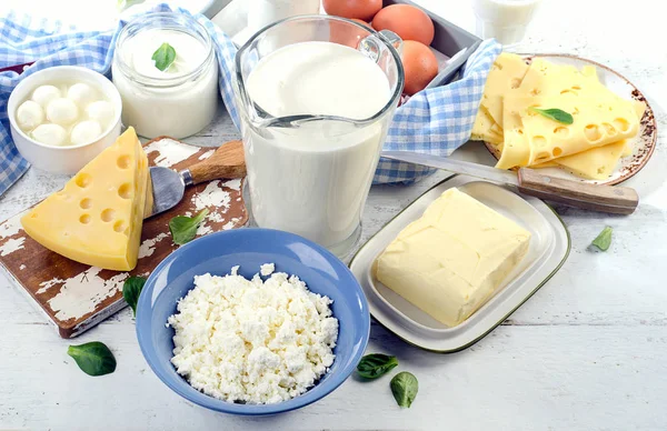 Productos lácteos en una tabla de madera blanca . —  Fotos de Stock